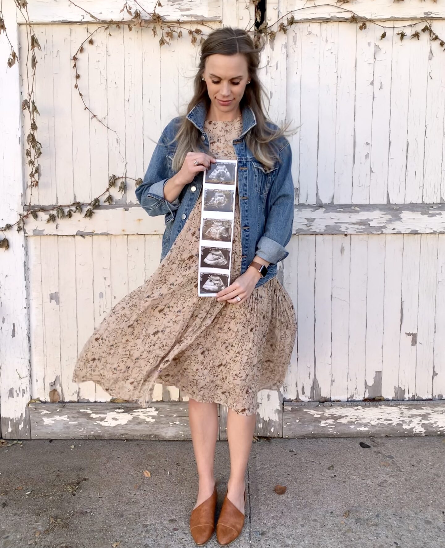 woman holding ultrasound pictures