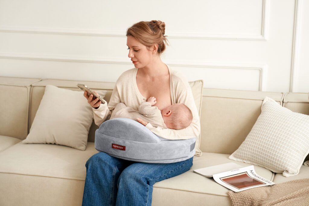 mom breastfeeding baby with momcozy nursing pillow