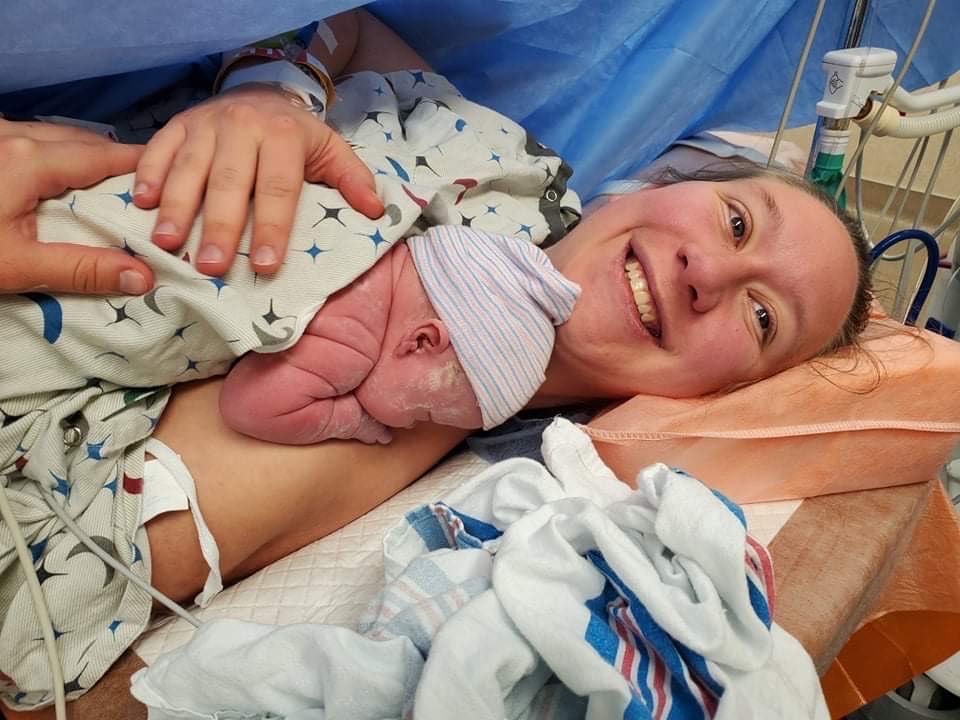 mama in OR holding baby skin to skin c-section