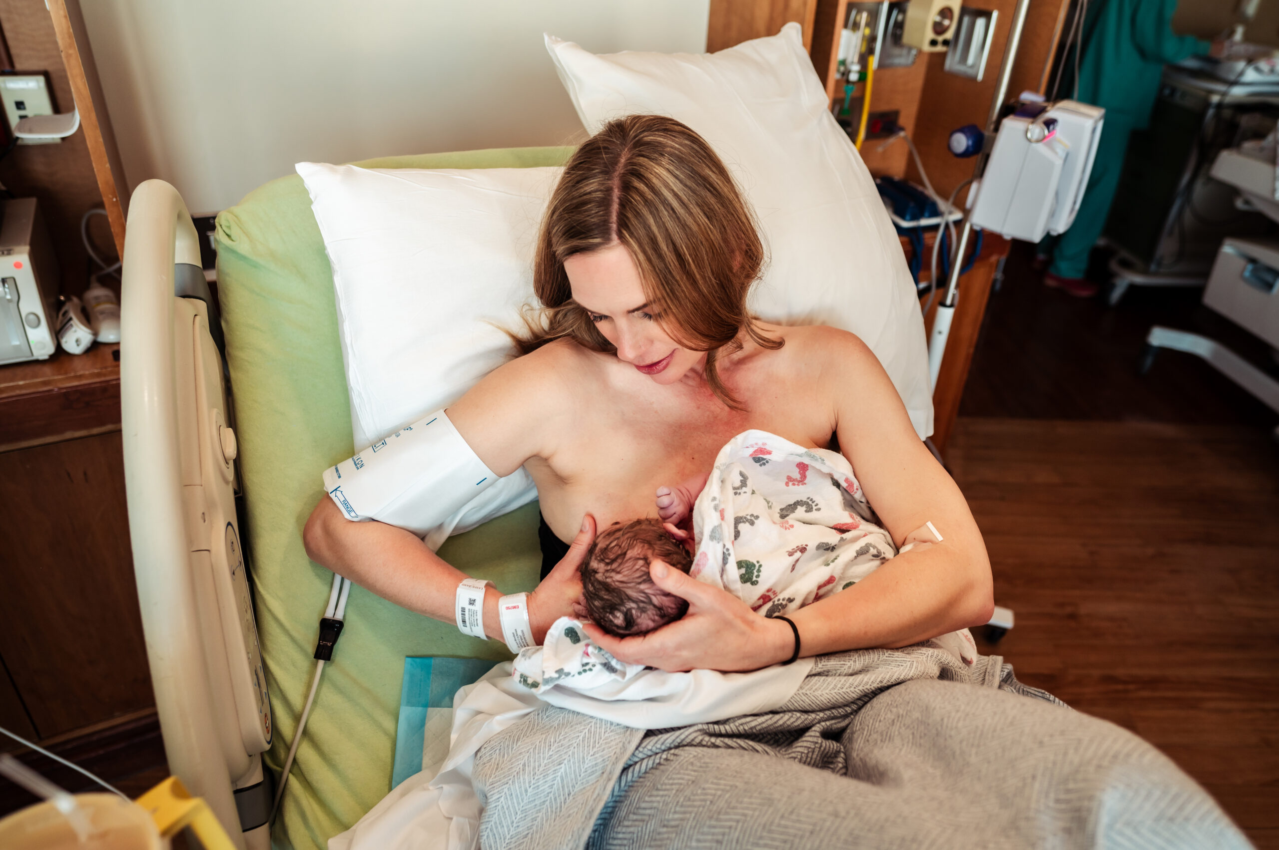 postpartum mom nursing newborn baby